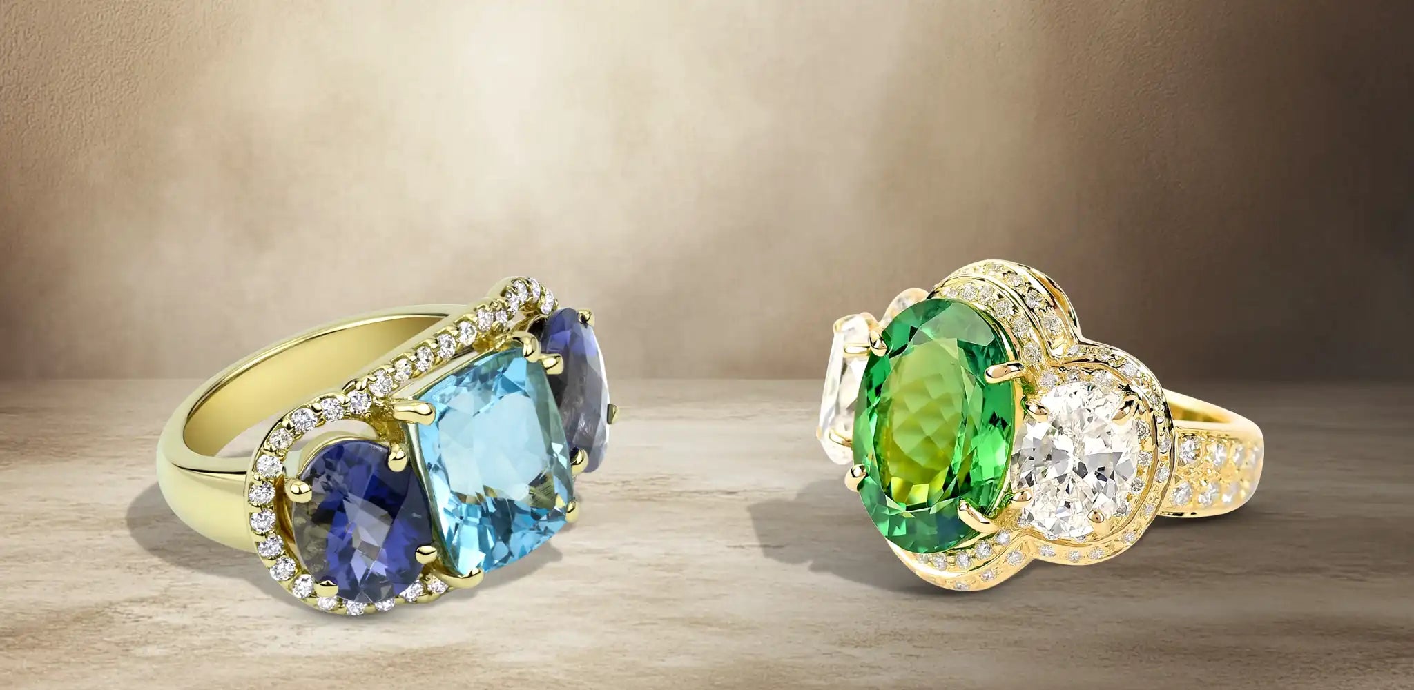 Two gold rings with blue, green, and clear gemstones accented with small diamonds | Singhvi Jewels Three-Stone Jewelry Collection