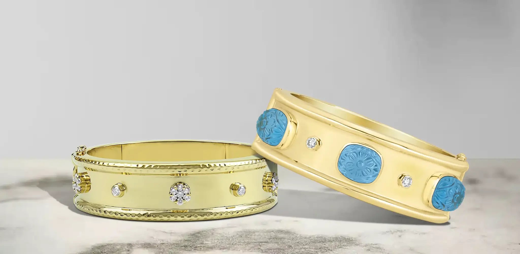 Two gold bangles with smooth polished bands, small diamond accents, and round blue carved stone details placed firmly | Singhvi Jewels Bangle Collection