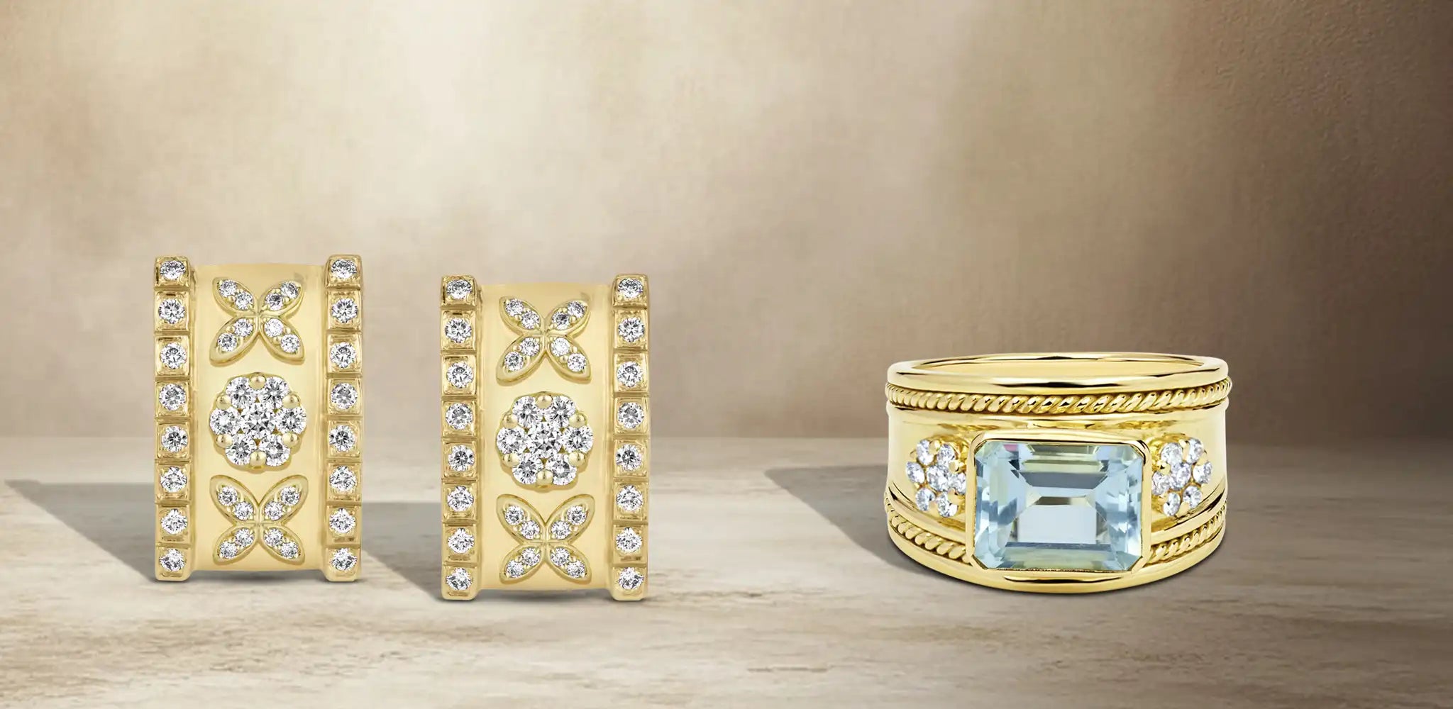 A pair of gold rectangular earrings with diamond floral details and a wide gold ring with a blue topaz gemstone and diamond accents | Singhvi Jewels Cigar Collection