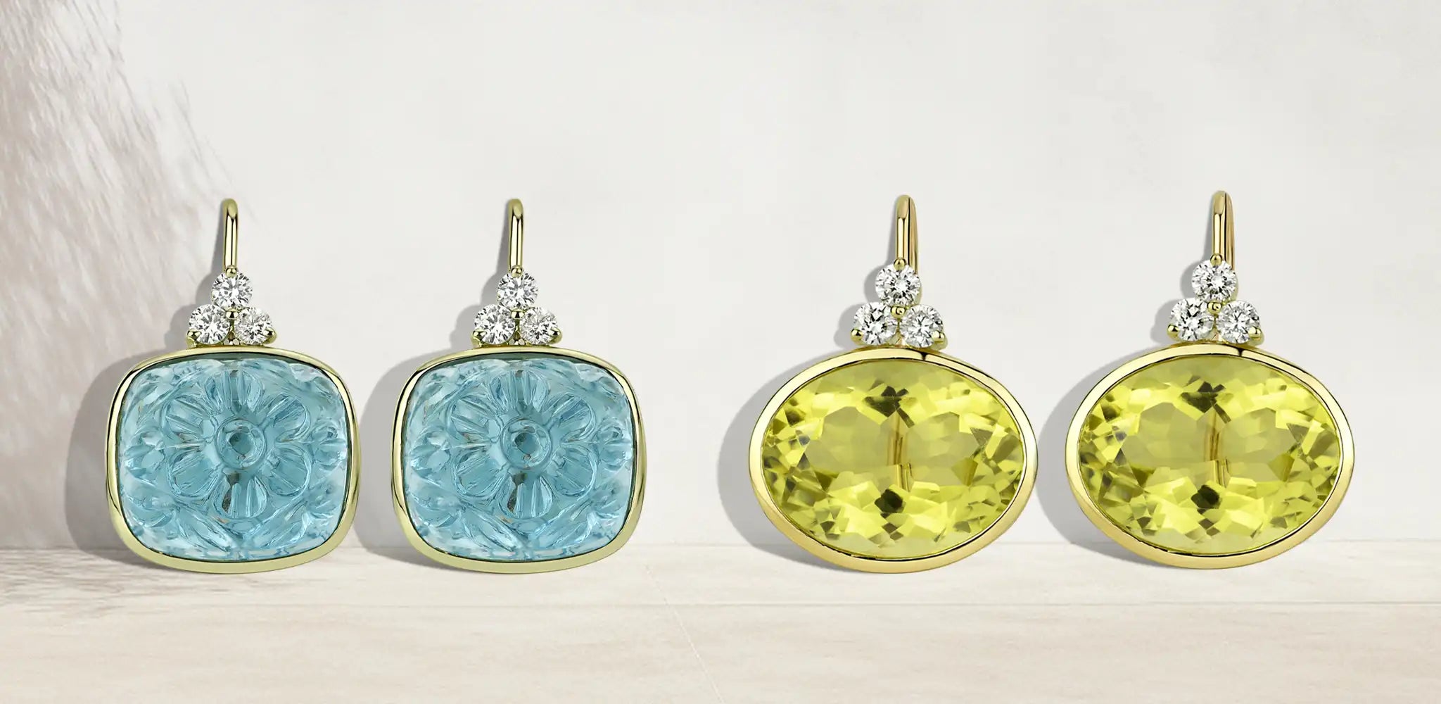 Two pairs of gold stack earrings with blue carved gemstones and yellow oval gemstones, each accented with small diamonds, on a soft neutral background | Singhvi Jewels Classic