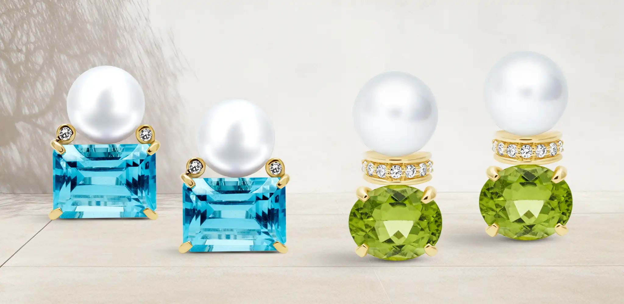 Two pairs of stack earrings with white pearls, blue topaz and peridot gemstones, and small diamond accents in gold settings | Singhvi Jewels Stack Collection